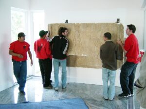 Professional long distance movers wrap and protect valuable artwork.