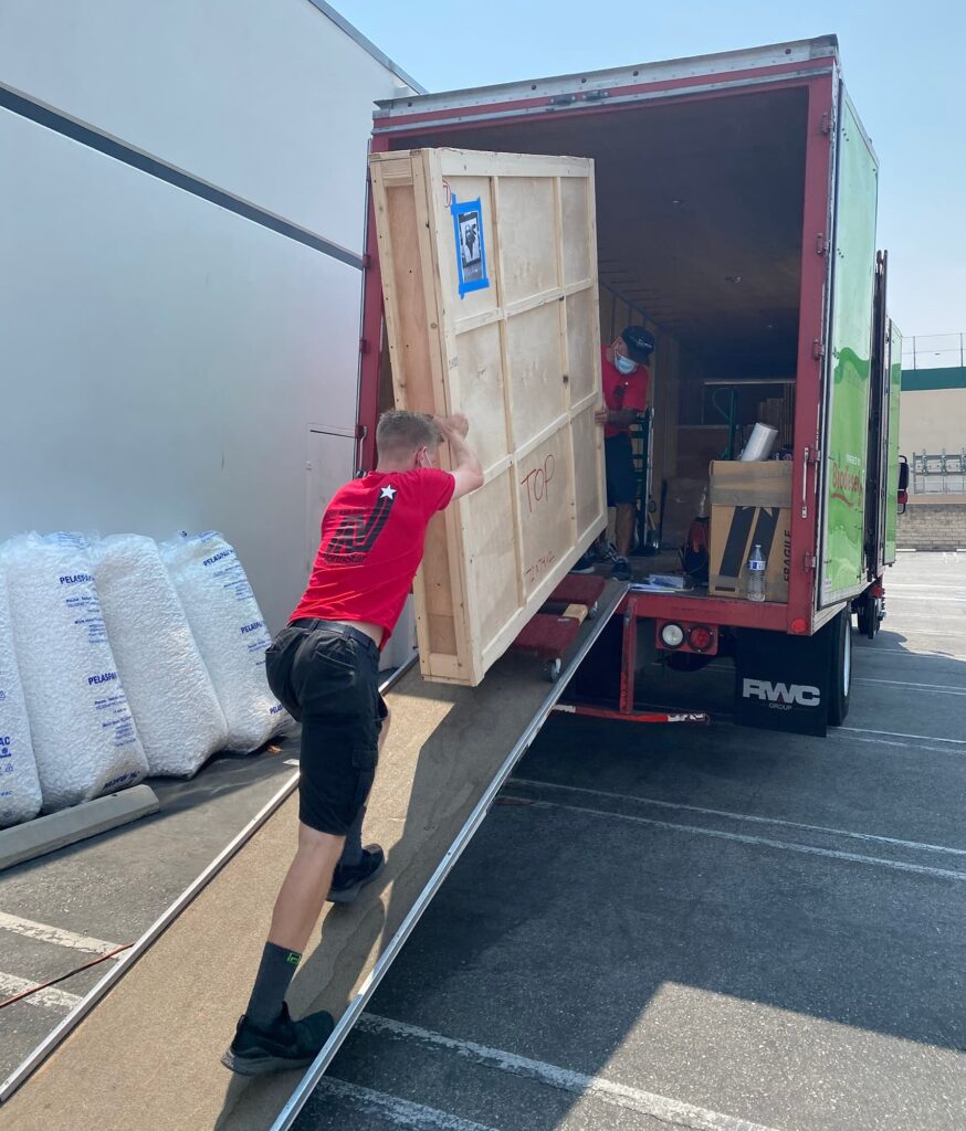 NorthStar Moving team loading artwork packed in a crate onto a moving truck.