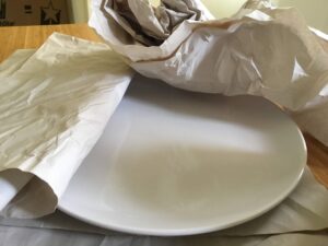 NorthStar Moving professional packing experts recommend using packing paper instead of newspaper to wrap and protect dishes