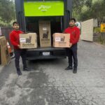 A NorthStar Moving team with our electric van during a move for the 49ers Foundation's 2026 annual Golden Getaway Weekend & Celebrity Golf Tournament
