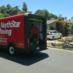 A mover inside our electric van while delivering part of our 200 boxes donation.